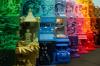 Rainbow-colored LEGO vignettes from green to brown, each showing minifigures and detailed miniature scenes.