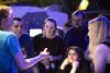  A visitor experience assistant engages with a group of adults at Science Lates. Photo: Eoin Carey